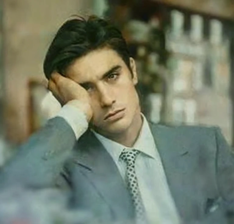 Johnny starts coughing suddenly after smoking too many cigarettes. His eyes widen in panic, and he drops the cigarette. The park setting remains, with birds flying in the background.