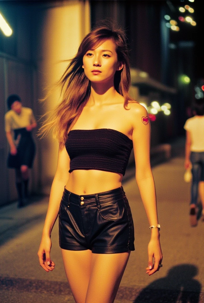 Vintage photo, 90s style, found footage, Japanese woman, 28 years old, portrait of a woman walking with her golden hair flowing, taken with a Polaroid camera, grainy emotional photo, looking at the viewer with a lovely smile, double eyelids, thin woman, long limbs, small face, black tube top, small shapely breasts, navel piercing, small red heart-shaped tattoo on her right shoulder, leather low-rise shorts, knee-high socks, high-heeled short boots, in the bustling city of New York at night, blurred background