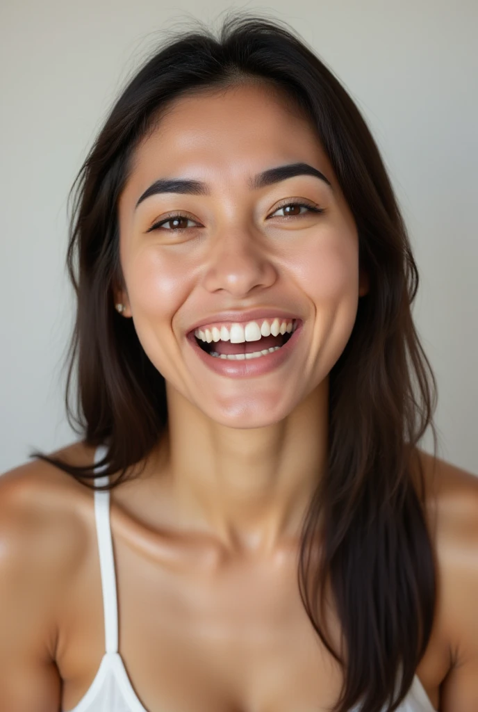 The image is a high-resolution portrait photograph of Eraa in a neutral studio. She is joyful:  The mouth forms a broad smile, with lips turned upwards. The eyes sparkle, often crinkling at the corners (crow's feet), and the eyebrows may lift slightly. The cheeks rise, creating a fuller appearance, and there may be a slight tilt of the head back as if the person is reveling in happiness. Overall, the expression radiates warmth and positivity.