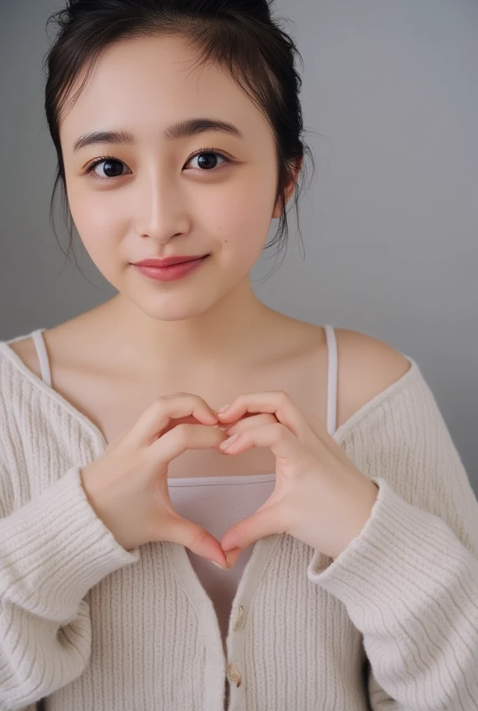 Only one woman with a cute smile wears cute, fluffy off-shoulder pajamas, makes a big heart shape with both hands, and poses them in front of her chest, View above collarbone、The background is a monotone 

