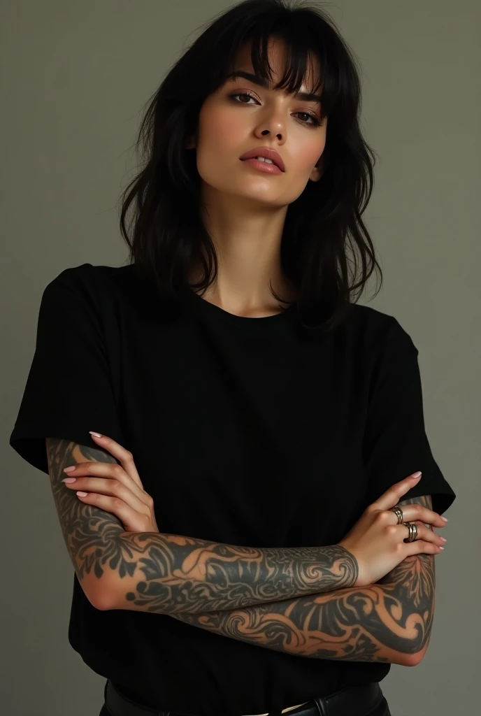 40-year-old tattoo artist with shoulder-length black hair and greenish eyes with tattoos on her body wearing a t-shirt that says sheila art tattoo & Body Piercings 