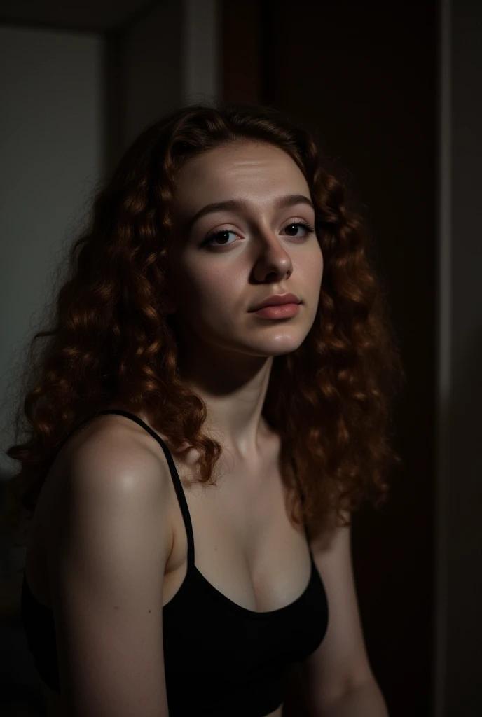 The image is a dimly lit, slightly grainy photograph of a young woman named Molly with a fair complexion and long, curly auburn hair that cascades down her left shoulder. She has a calm, neutral expression on her face, with her eyes slightly open and looking directly at the camera. Her hair is styled in loose, voluminous curls that frame her face. She is wearing a black spaghetti-strap top, which reveals a glimpse of her shoulders and upper chest.