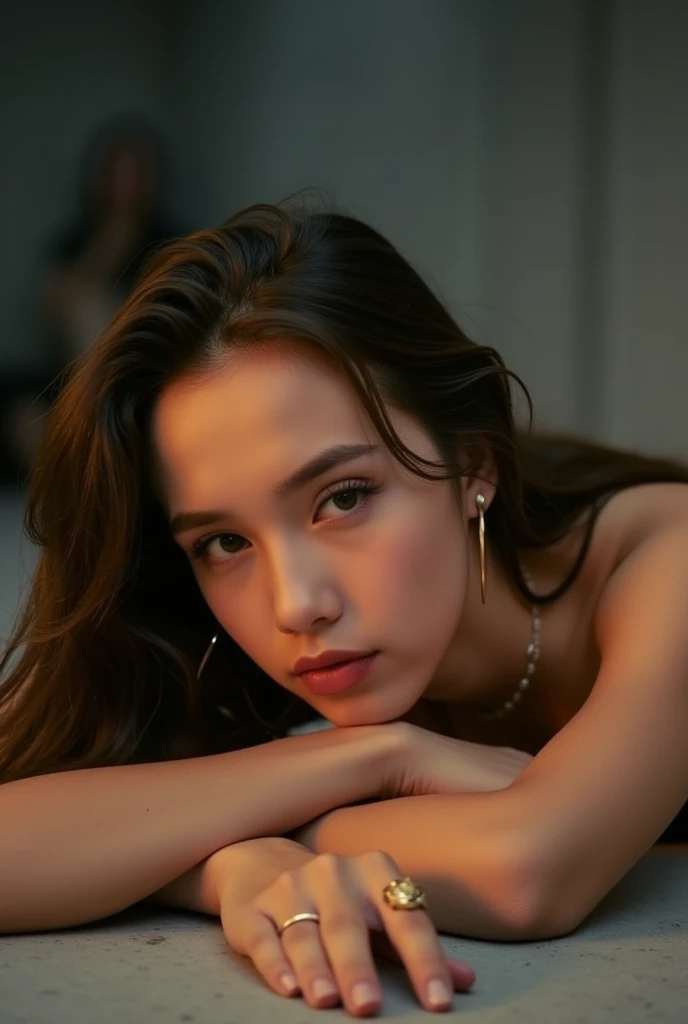 a close-up portrait of a young woman lying on the floor. She is looking directly at the camera with a serious expression on her face. Her hair is styled in loose waves and falls over her shoulders. She has a pair of gold hoop earrings on her left ear and a gold ring on her right hand. The background is blurred, but it appears to be an indoor setting with a concrete floor. The lighting is soft and warm, creating a dreamy atmosphere. The overall mood of the image is somber and contemplative. aesthetic posing