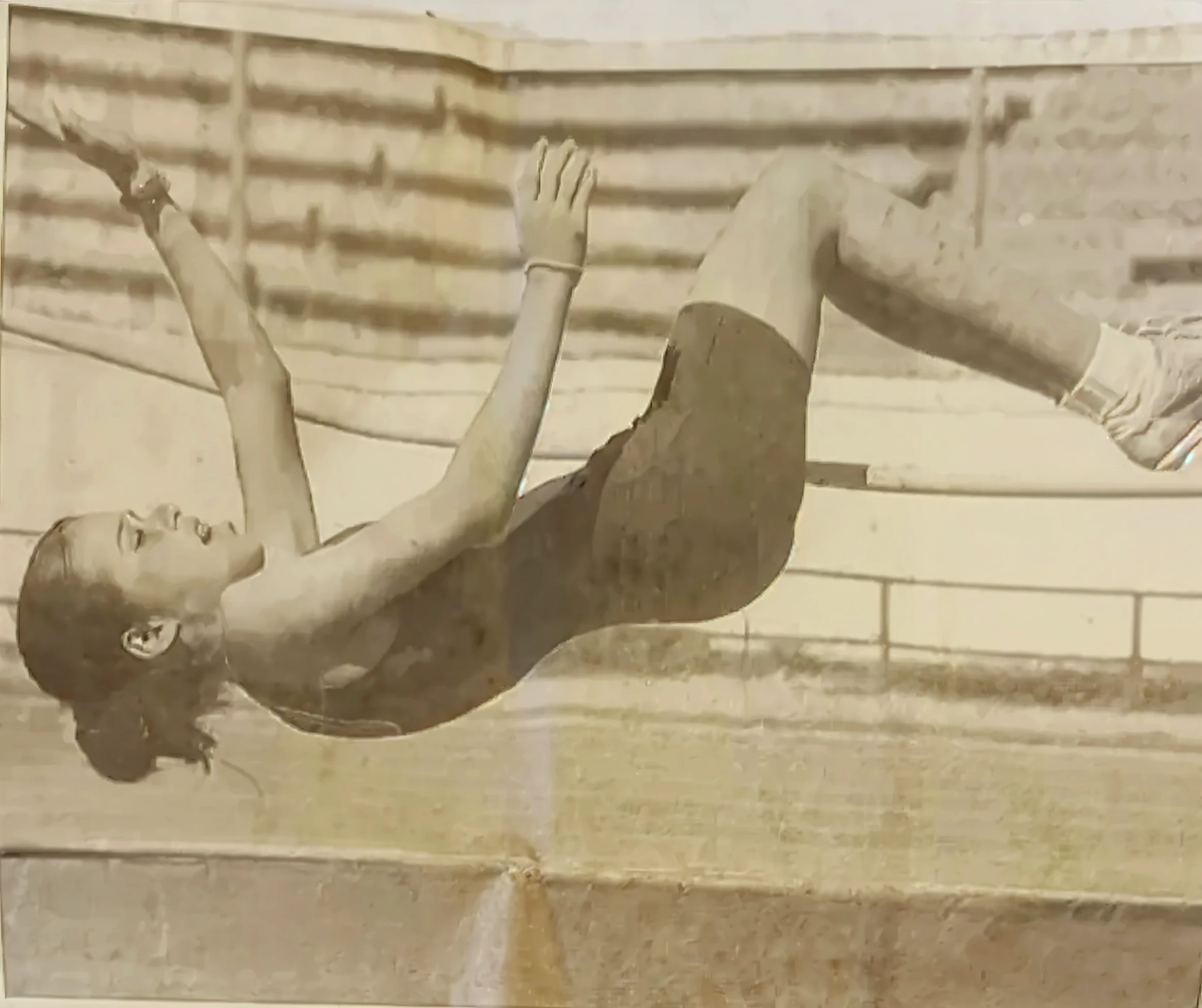 A woman wearing a swimsuit is doing somersaults in the pool, in water! Up to the shoulder, butterfly, olympic diving springoard, Backshots, Swimming, back - shot, viktoria gavrilenko, Award-winning color photo, profile shot, body shot, leaping towards viewer, speedo, in water up to her shoulders