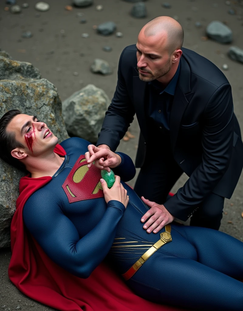 muscular attractive Nicholas Alexander Chavez with an undercut haircut combed back, short beard, wearing blue, form-fitting Superman suit with gold accents in the waistband, his chest displays the iconic "S" symbol. Superman's traditional red cape is present, attached to the shoulder and flowing behind him, lies on a rocky floor leaning against a rock, sore, with his mouth slightly open, he appears weak and in pain. Expression of pain, with blood on his face. Standing next to Superman is a bald man, dressed in a dark suit, The bald man holds a bright green crystal in his hand near Superman's chest
