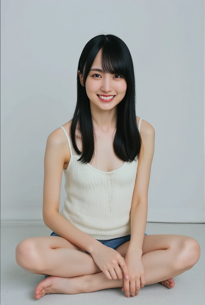 Only one cute smiling woman is wearing a camisole and posing cross-legged, View above collarbone、The background is a monotone 、
