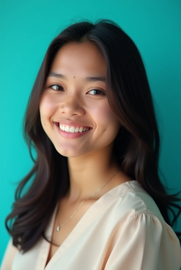 A young south sri lankan girl with dark brown hair and a confident smile.  She dresses in a office blouse. The girl is positioned against an aqua color backdrop with face side and posing for a CV profile picture.