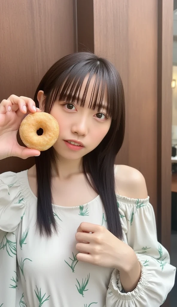   photo taken with a Fuji camera  , Realistic,  best quality,  asian woman,  white skin, Narrow Face, Oval Face, Small round eyes,  single eyelid,   teardrop nose with a round tip  ,   Plump Lips, length,  soft,  black hair,   face straight forward and face sideways  .., Holding a doughnut in your right hand 、 cover your face so that the hole in the doughnut fits your right eye .,  CACP,  white off-shoulder round neck dress with a green leaf pattern ,  Picture taken with ,  sweet coffee shop vibe 