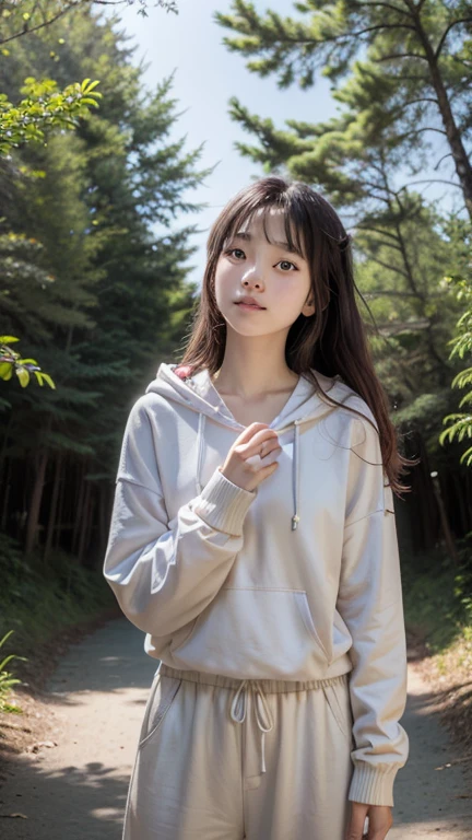 A high-quality photograph of an Asian woman beauty pose with long, wavy brown hair standing in a sunlit forest. She is wearing a white hoodie , yellow pants, and a bracelet on her left wrist. She holds a small bunch of pine cones in her left hand. The lighting is natural, soft, and warm, coming from the setting sun behind her. The camera angle is slightly low, looking up at her. The background is blurred with tall trees and greenery, creating a serene and peaceful atmosphere. The composition follows the rule of thirds, with the woman positioned off-center. The overall aesthetic quality is very high, with a calm and tranquil mood.