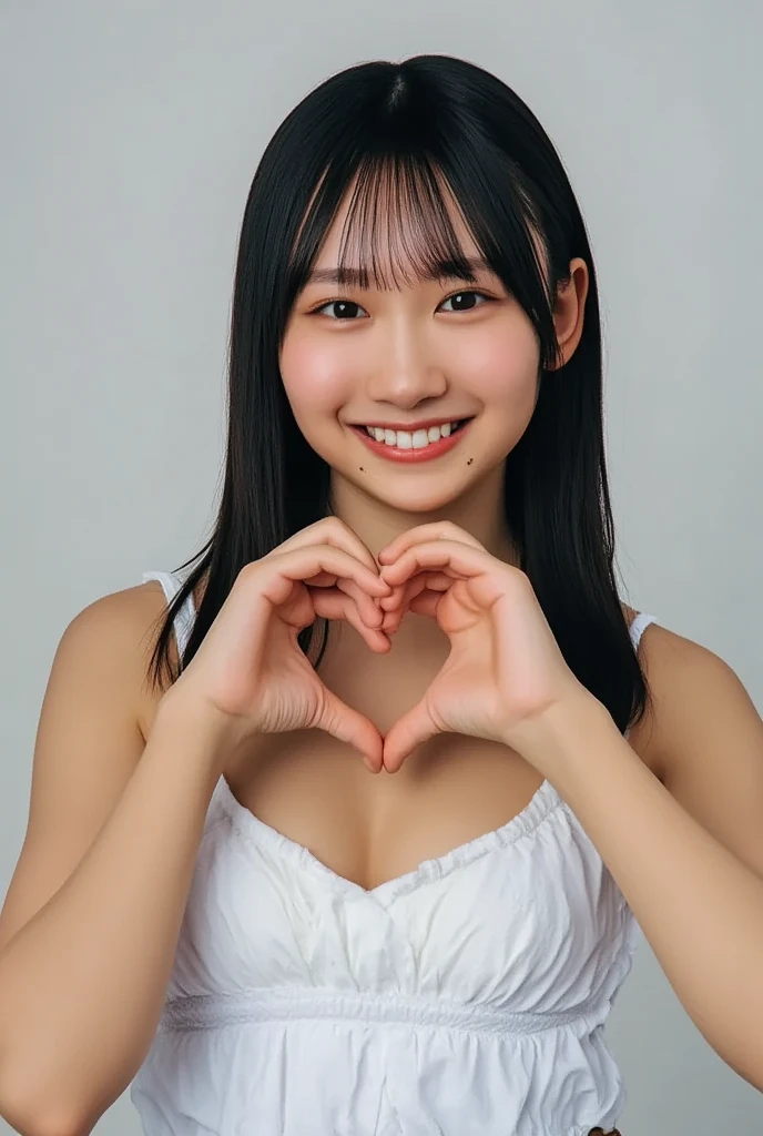 Only one smiling woman poses wearing a camisole, making a firm big heart shape with both hands, and holding it in front of her chest, View above collarbone、The background is a monotone 、
