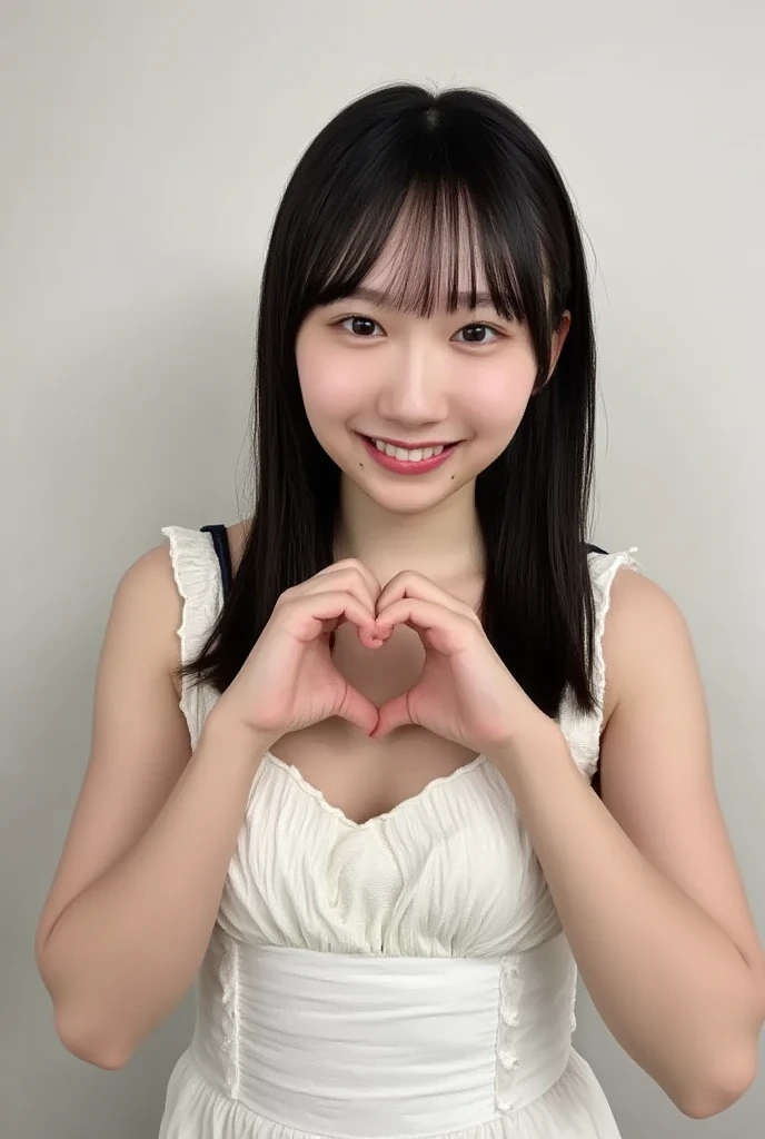 Only one smiling woman poses wearing a camisole, making a firm big heart shape with both hands, and holding it in front of her chest, View above collarbone、The background is a monotone 、
