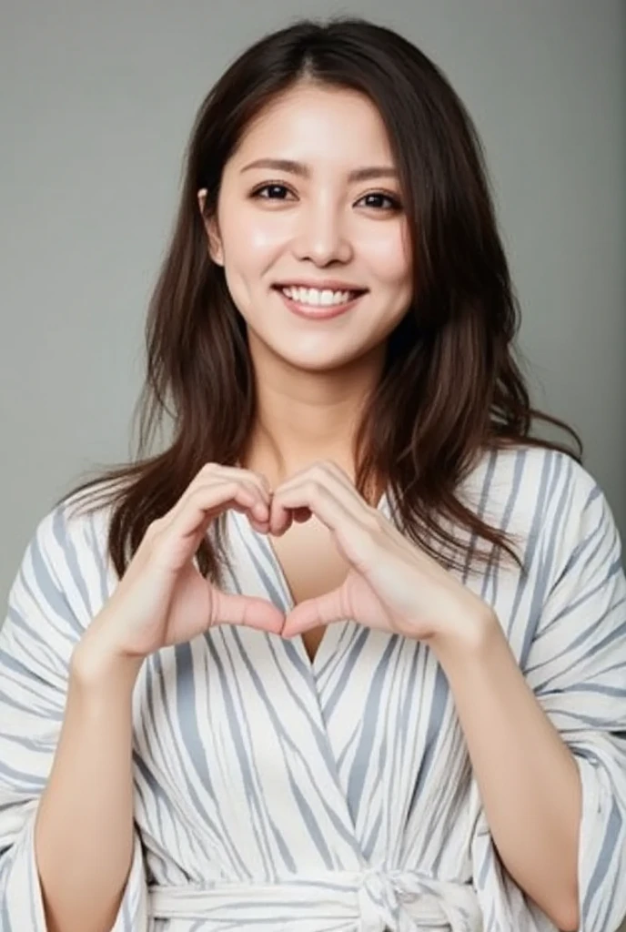 A smiling woman is posing alone wearing off-the-shoulder pajamas, making a firm big heart shape with both hands, and holding them in front of her chest, View above collarbone、The background is a monotone 、
