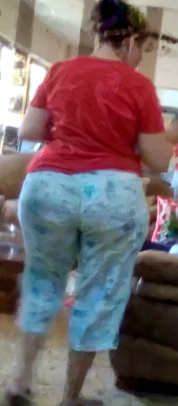 araffe in a blue shirt and purple shorts is putting a bag of candy into a white box, bright blue shiny lingerie, bending over, side shot, view from the back, picture from behind, photo taken from behind, seen from the back, waist - shot, medium shot taken from behind, shot from the back, somewhat bent over