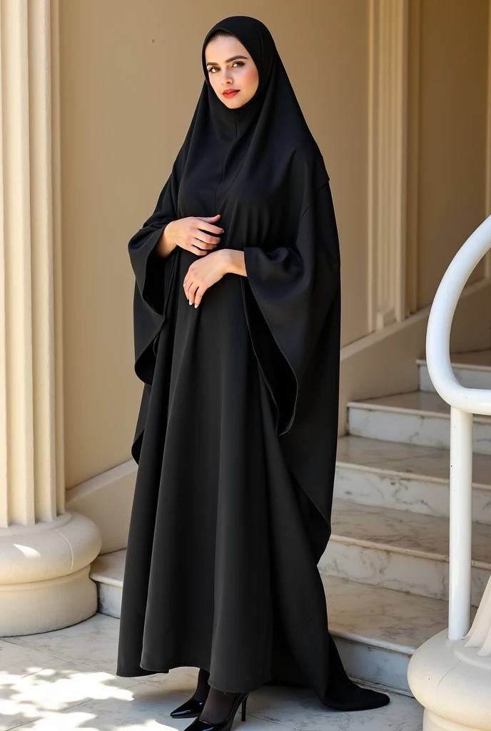 she is dressed in a traditional black chador that covers her head, body. the chador has a shiny. the woman is wearing black tights and black heels, has a shiny. her hands are positioned with one resting on her chest and the other placed on top of it, fingers gently touching the fabric of her chador. she has a neutral expression, looking directly at the camera. her eyes are partially visible, with a subtle squint. the lighting is natural daylight, casting shadows to the right side of her body and creating a high-contrast effect on the fabric of her attire. the background features a beige wall with vertical ridges, and a curved white handrail or step is visible on the right side of the image. the floor appears to be marble with light-colored tiles. the overall composition is centered, with the subject occupying most of the frame, emphasizing the traditional attire against the simple background.