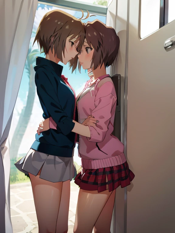 Two cute girls in short skirts are kissing 