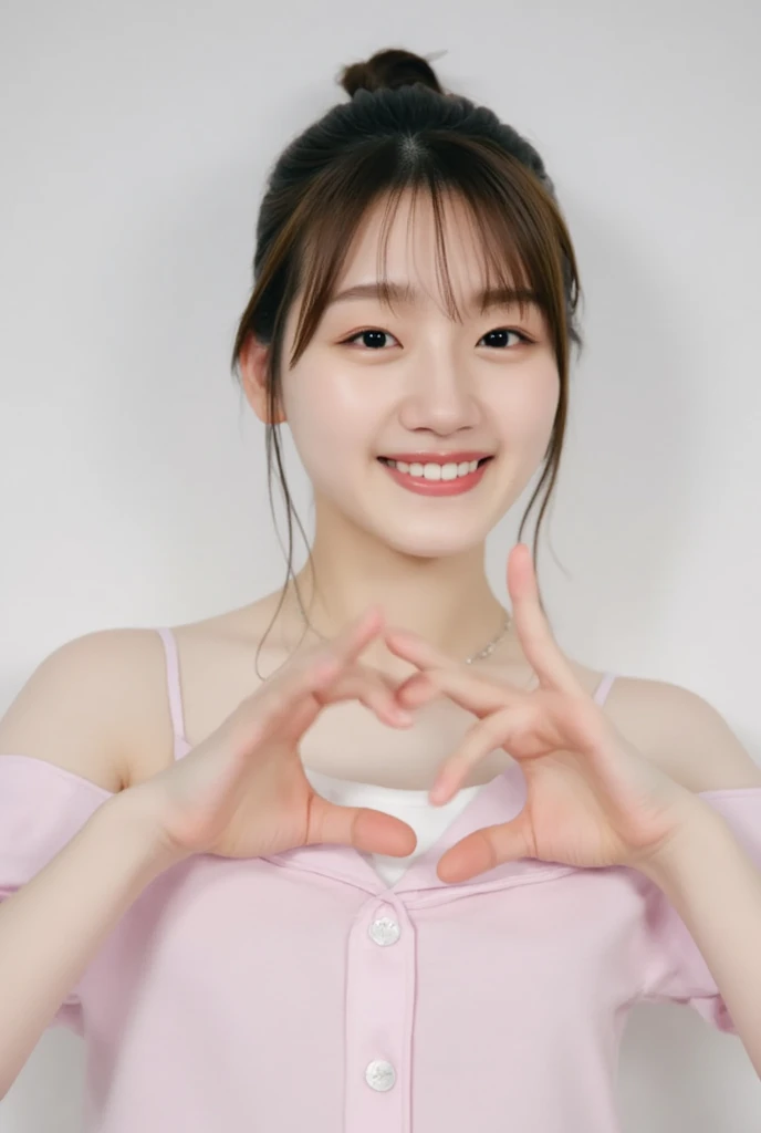 A smiling woman poses alone wearing off-the-shoulder pajamas in pastel colors that convey warmth simply by touching them softly and softly, making a firm, large heart shape with both hands, and holding them in front of her chest, View above collarbone、The background is a monotone 、
