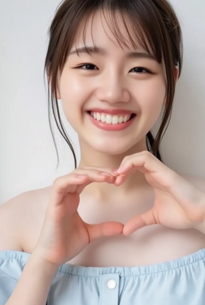 A smiling woman poses alone wearing off-the-shoulder pajamas in pastel colors that convey warmth simply by touching them softly and softly, making a firm, large heart shape with both hands, and holding them in front of her chest, View above collarbone、The background is a monotone 、
