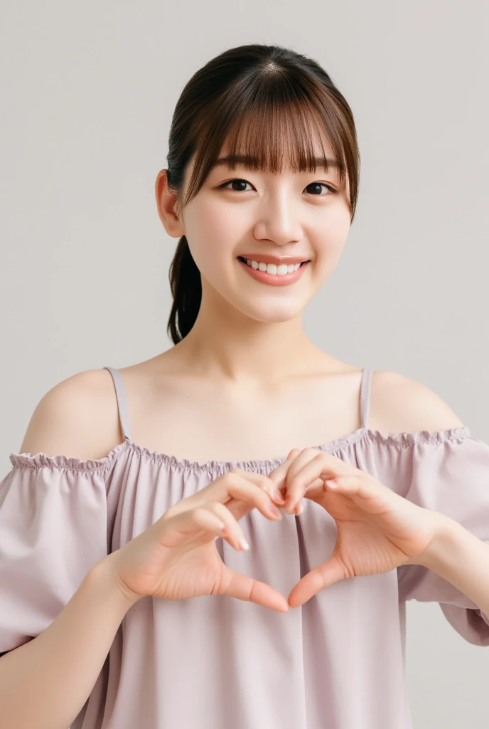 A smiling woman poses alone wearing off-the-shoulder pajamas in pastel colors that convey warmth simply by touching them softly and softly, making a firm, large heart shape with both hands, and holding them in front of her chest, View above collarbone、The background is a monotone 、
