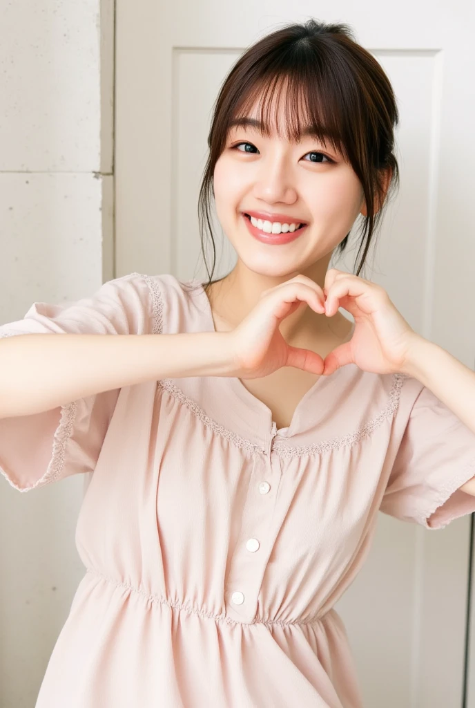 A smiling woman poses alone wearing off-the-shoulder pajamas in pastel colors that convey warmth simply by touching them softly and softly, making a firm, large heart shape with both hands, and holding them in front of her chest, View above collarbone、The background is a monotone 、
