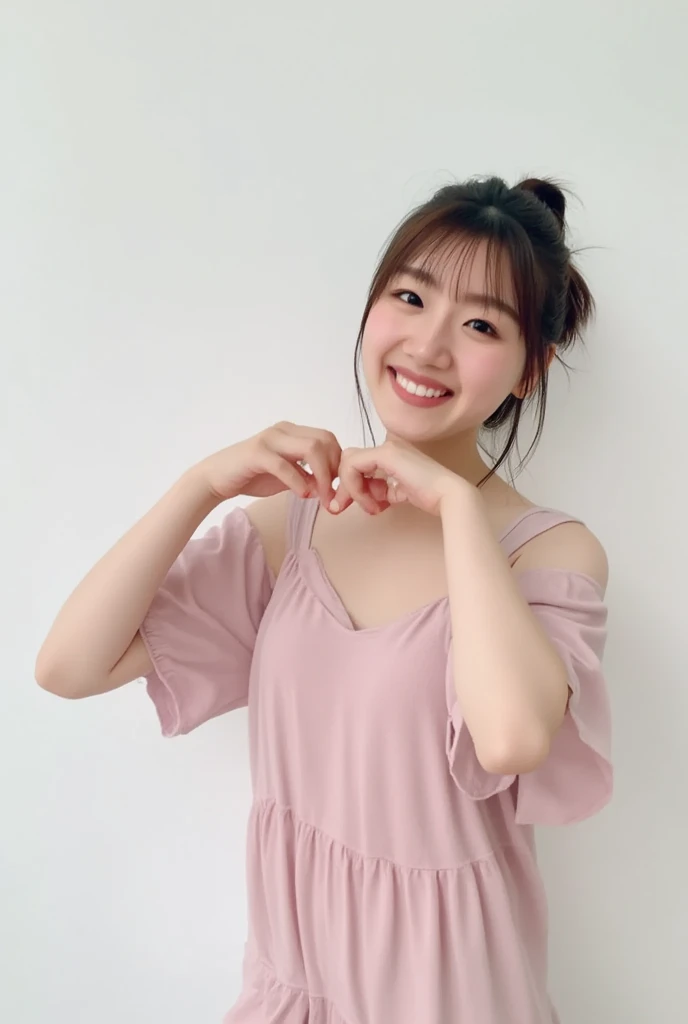 A smiling woman poses alone wearing off-the-shoulder pajamas in pastel colors that convey warmth simply by touching them softly and softly, making a firm, large heart shape with both hands, and holding them in front of her chest, View above collarbone、The background is a monotone 、
