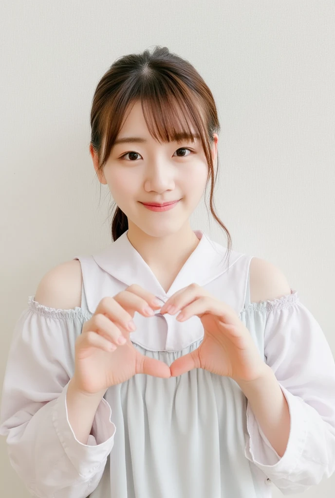 A smiling woman poses alone wearing off-the-shoulder pajamas in pastel colors that convey warmth simply by touching them softly and softly, making a firm, large heart shape with both hands, and holding them in front of her chest, View above collarbone、The background is a monotone 、
