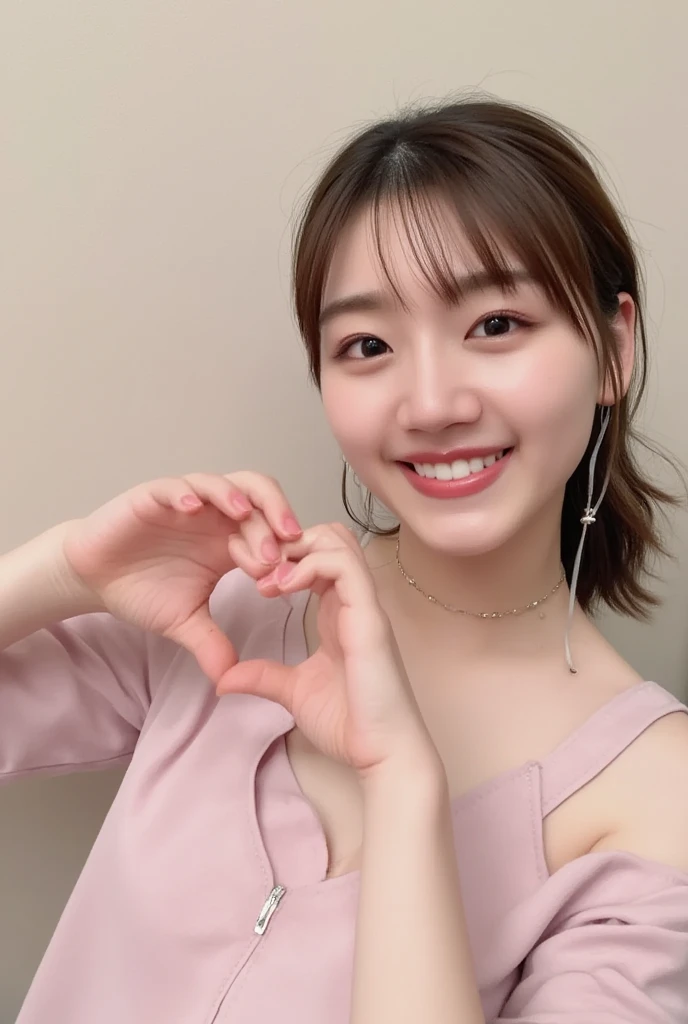 A smiling woman poses alone wearing off-the-shoulder pajamas in pastel colors that convey warmth simply by touching them softly and softly, making a firm, large heart shape with both hands, and holding them in front of her chest, View above collarbone、The background is a monotone 、
