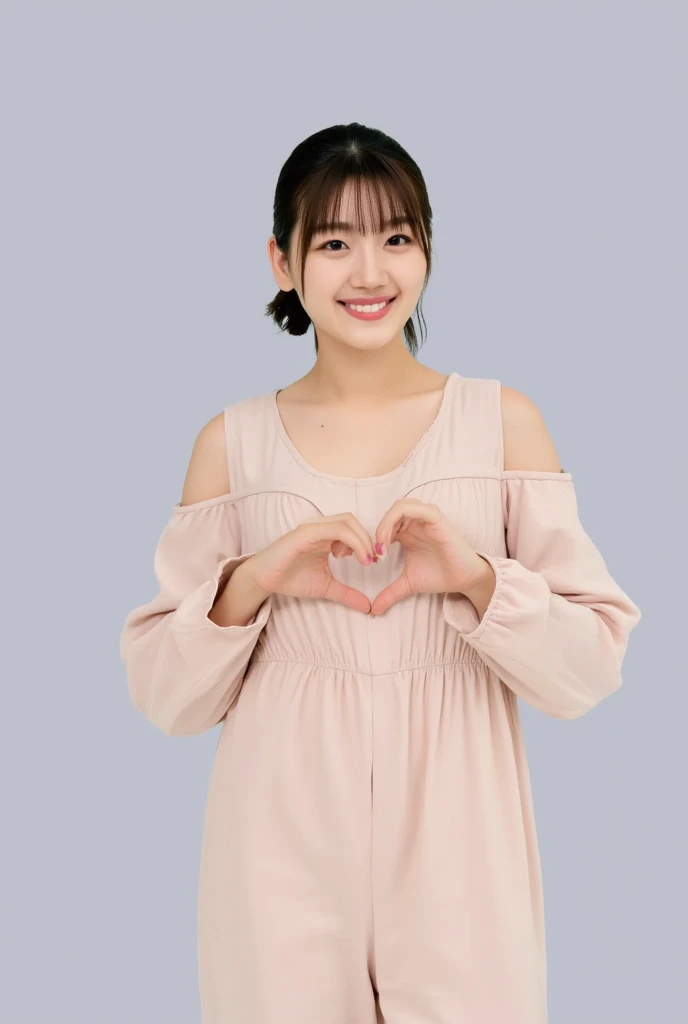 A smiling woman poses alone wearing off-the-shoulder pajamas in pastel colors that convey warmth simply by touching them softly and softly, making a firm, large heart shape with both hands, and holding them in front of her chest, View above collarbone、The background is a monotone 、
