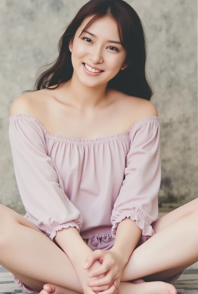 A smiling woman poses cross-legged by herself wearing pastel-colored, off-the-shoulder pajamas that convey warmth simply by touching them softly and softly, View above collarbone、The background is a monotone 、
