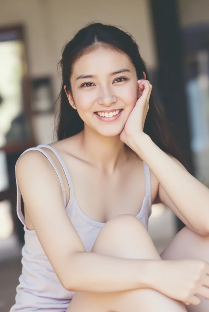 A smiling woman poses cross-legged by herself wearing pastel-colored, off-the-shoulder pajamas that convey warmth simply by touching them softly and softly, View above collarbone、The background is a monotone 、
