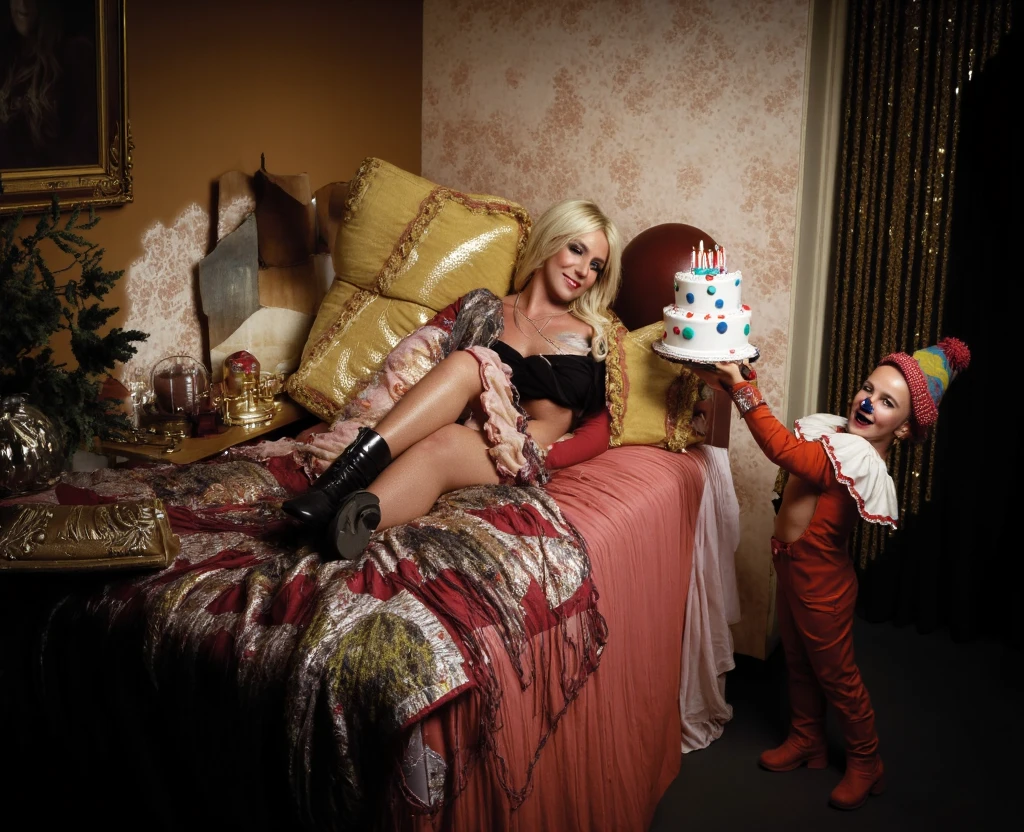 A vintage-style portrait of a young woman resembling Britney Spears, reclining on a bed covered in patchwork crochet throws and a patchwork quilt. She is dressed in a flowing, patterned, whimsical,  boho-inspired ensemble in rosy-pink and cream colors with a lace overlay. She appears relaxed, with a soft smile, and holds a book. A small , dressed as a clown, stands beside her, holding a birthday cake, giving the scene a slightly surreal, fairytale-like quality.  The background features muted tones of brown, gold, and cream, including a framed portrait, a circular decorative alcove, and a beaded curtain, all with textured surfaces that evoke a warm, rich, vintage atmosphere.  Render in a style evocative of a 1920s/1930s still life or a vintage magazine cover,  using a shallow depth of field and a warm light, and capture the soft lighting and textures with detail across rich colors and hues and apply color grading that mimics the mood of the original picture, aiming for a similar color palette and lighting effects . Simulate a 50mm medium format lens,  with a slight vignette and use a cinematic color grading. Focus on the soft, romantic ambiance. britney.