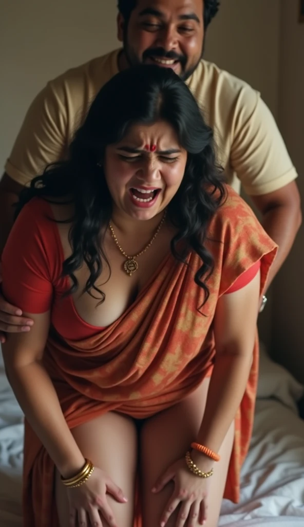 An Indian woman with medium plus size body, thighs visible in saree, busty breasts , bends over in bed and crying loudly with pain and her drunken husband is standing behind her, pushing her hard and laughing background blur