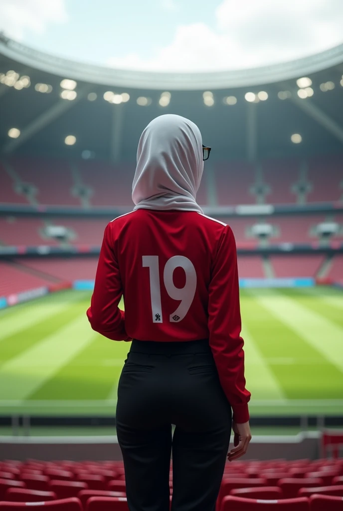 A beautiful hijab woman wearing an Indonesian national team football jersey is watching football at the Qatar stadium
