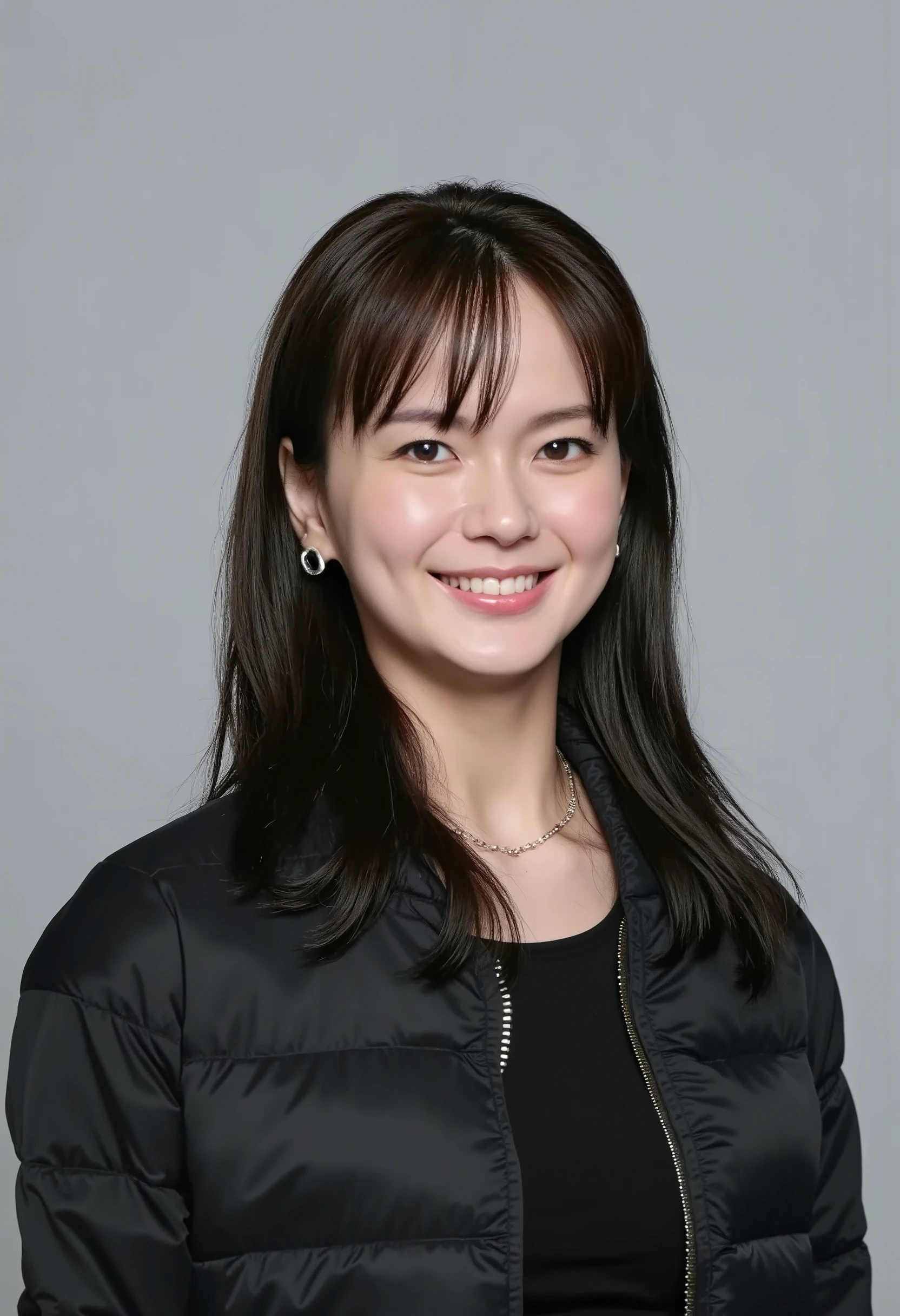 young Japanese woman、 Mikako Abe、black hair、 ear piercing、smile、 beautiful alignment of teeth、 black down jacket、Gray background

