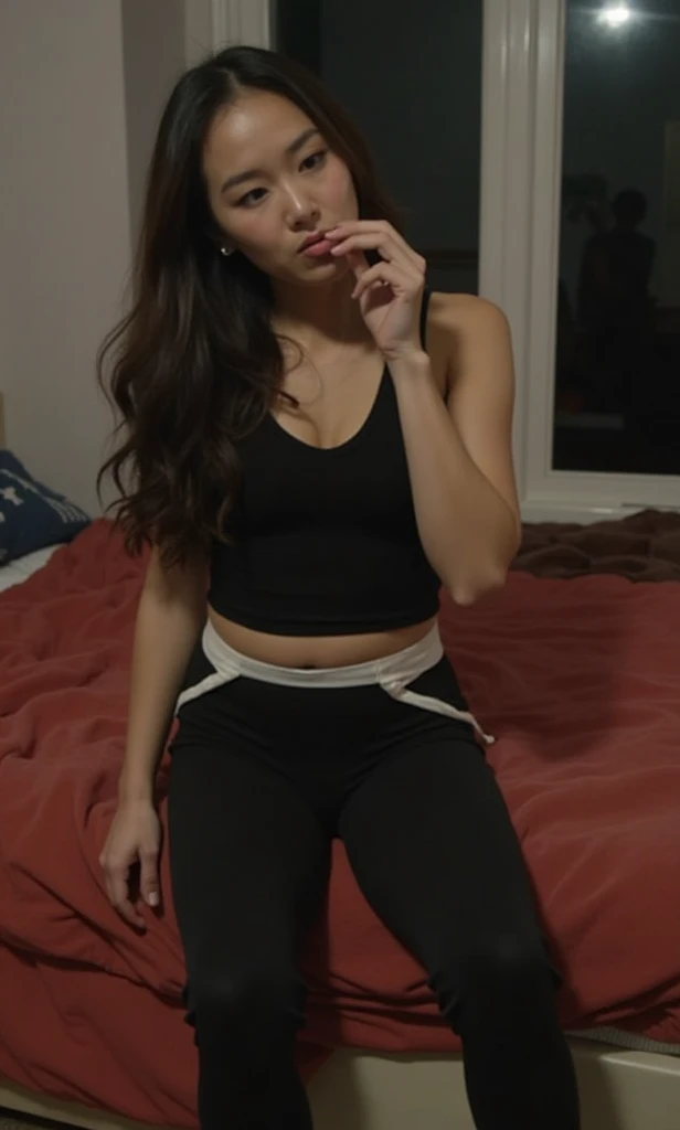 A very beautiful 45 year old woman, lying on her stomach, is wearing a black t-shirt and tight, short pants, her straight black hair is loose, her eyes are open and small moans are coming from her mouth, his face is sweaty, sweat ran down his white t-shirt, making it see-through.