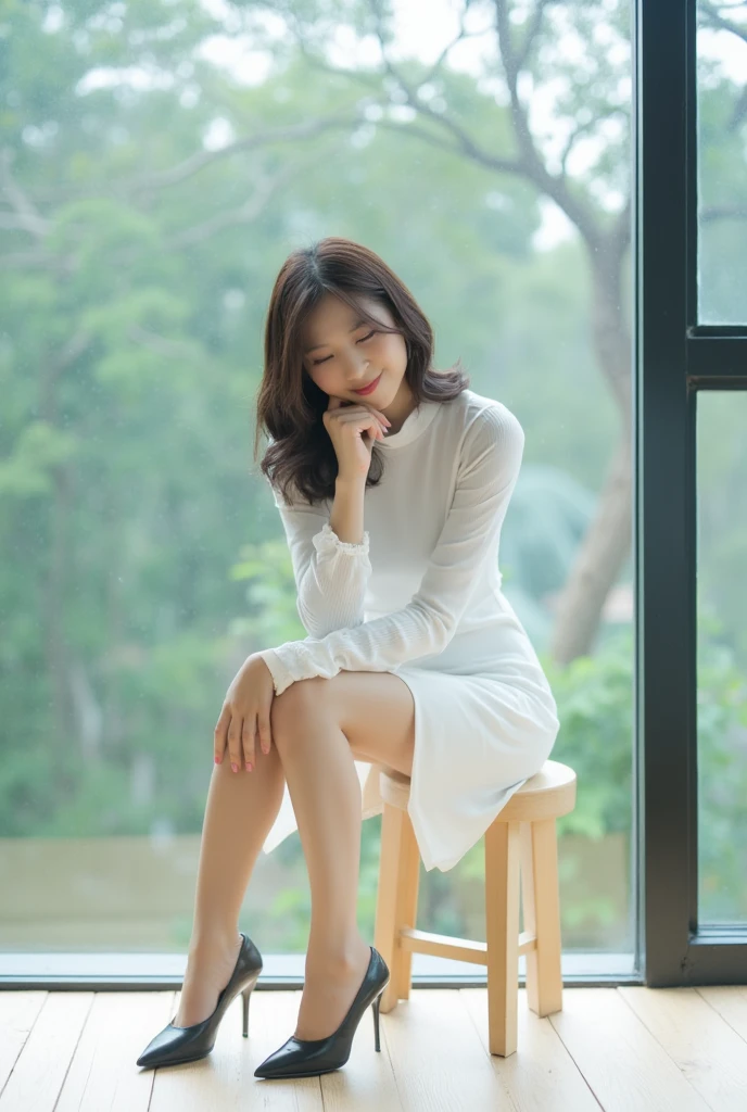 The image shows a young asian woman sitting on a wooden stool in front of a large window. She is wearing a white dress with a high neckline and long sleeves. Her hair is styled in loose waves and she is wearing black high heels. The woman is resting her chin on her hand and appears to be deep in thought. The window behind her is made of glass and has a view of trees outside. The floor is made up of light-colored wood planks. The overall mood of the image is peaceful and contemplative.