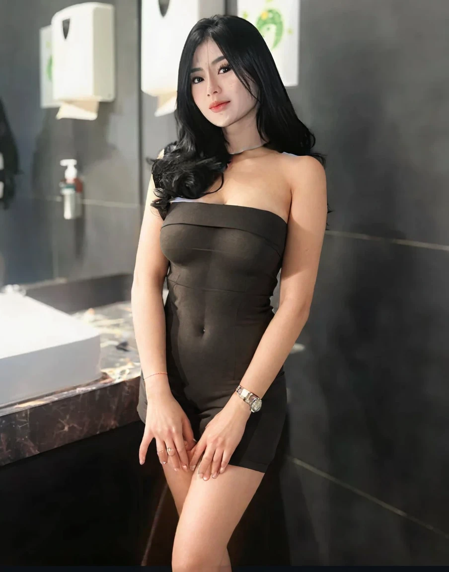 a woman, straight black hair, body in the picture, posing for photo, social shirt, social cause, pearl necklace, silver gala dress, gold bracelet