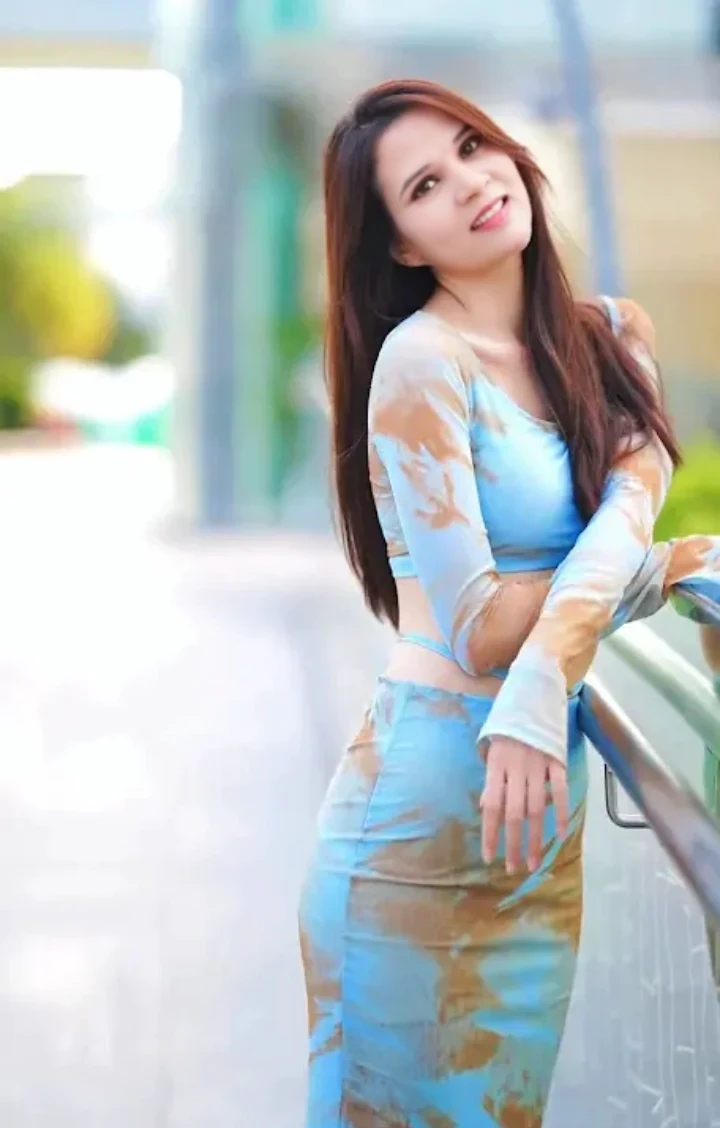 A girl with blue green outfit,