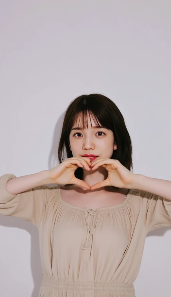 Only one woman with a cute smile wears cute, fluffy off-shoulder pajamas, makes a big heart shape with both hands, and poses them in front of her chest, View above collarbone、The background is a monotone 

