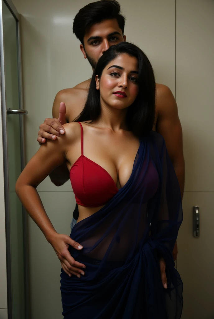 woman, dark blue saree, red blouse, navel, deep cleavage, saree dropped on the floor. her husband standing behind and squeezing her hip flesh, biting her neck. she is moaning in pleasure, in bathroom and gazing at the camera.
