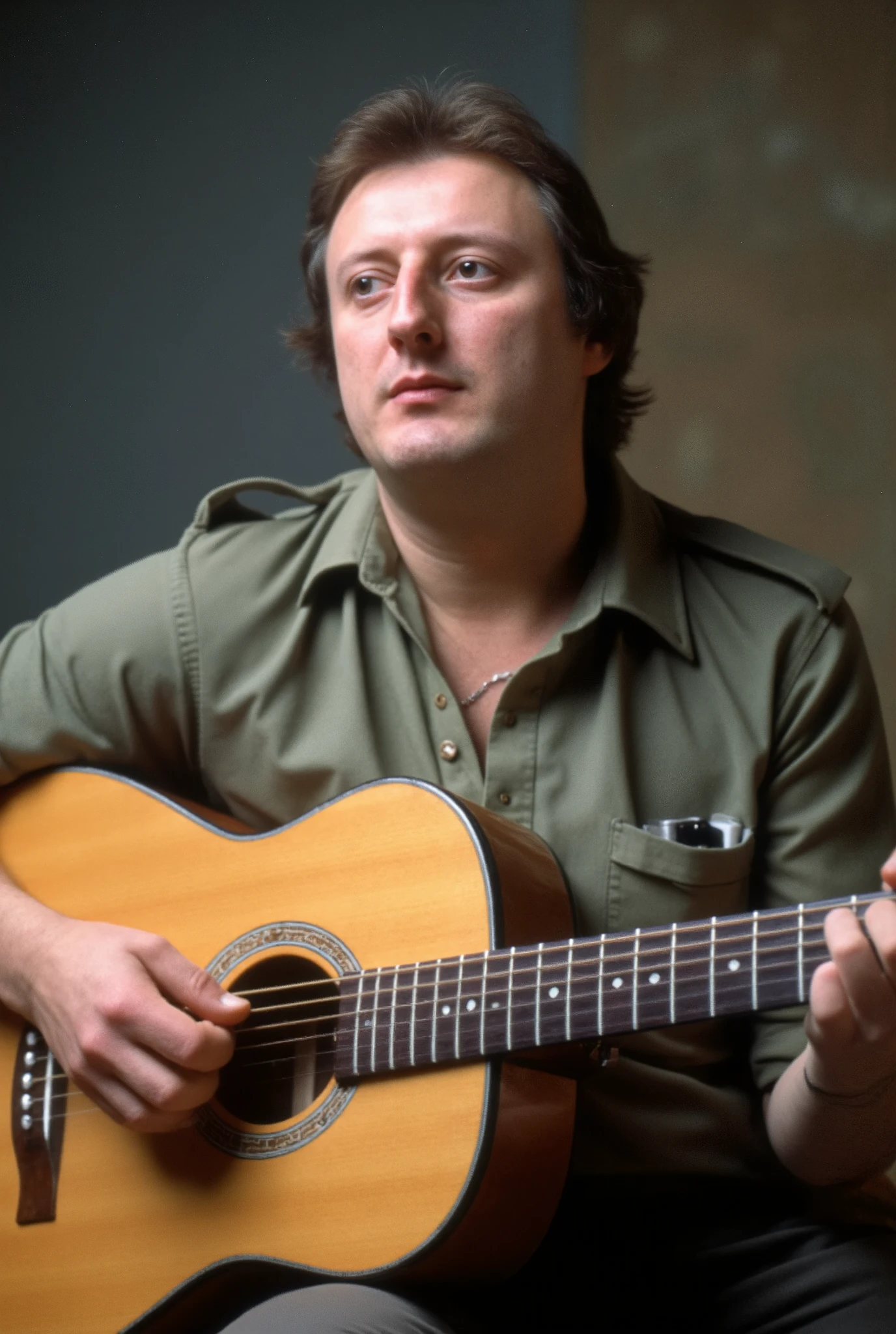 A high-resolution photograph of Eric Bristow playing an acoustic guitar