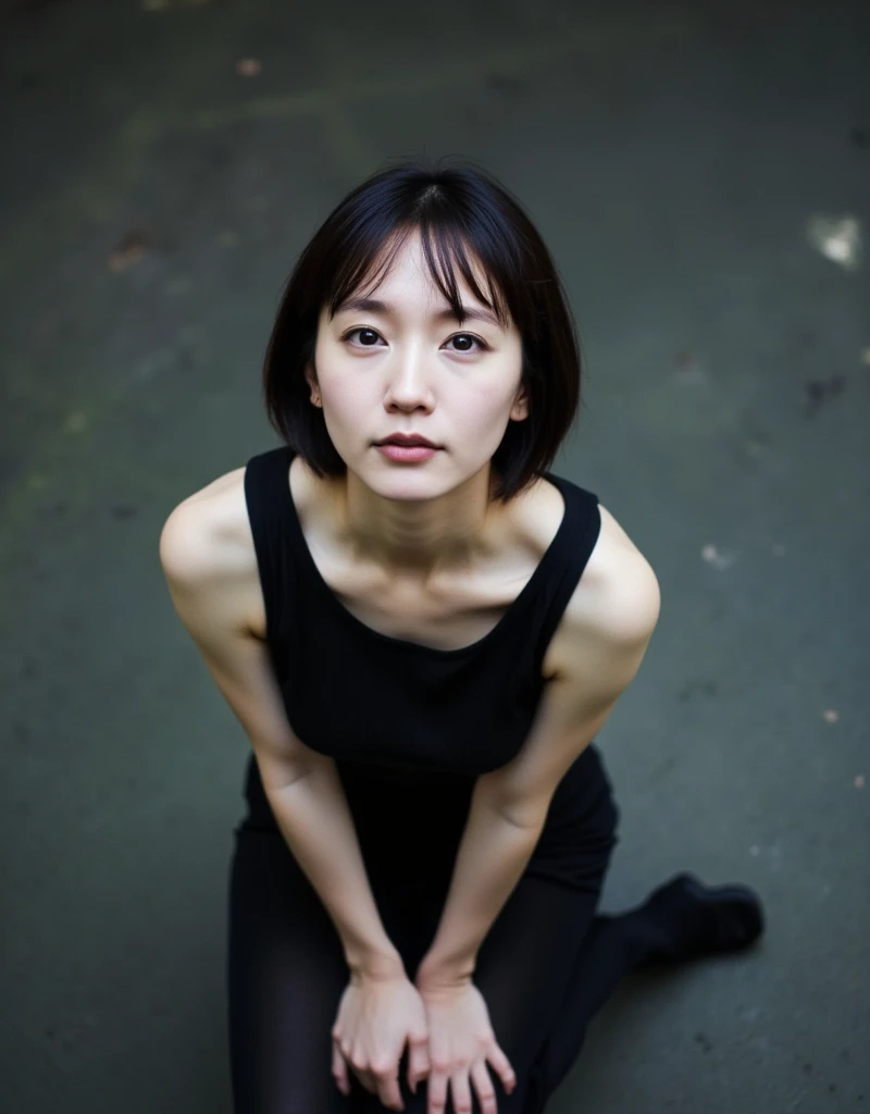 A masterpiece of surreal film photography with exquisite detail. ((Anatomically perfect and accurate body depiction: 1.6)), (bird's view shot of a woman looking down from above, extreme close-up of face: 1.6) Realistic, cute Asian woman in a black tank top, black hair with bangs, (sitting on a stool: 1.6), (one leg crossed on knee: 1.6), (extreme punk makeup: 1.7), (dark, thick eyeliner, black lipstick, black nails: 1.8), woman looks up at the camera from below, expressionless, focus on face