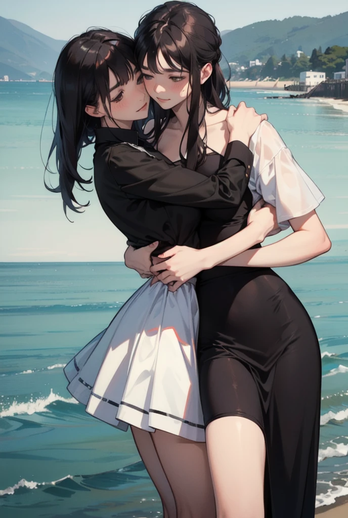 Two women are hugging each other; one is facing outward, while the other is embracing her from behind. The background is a seaside setting.