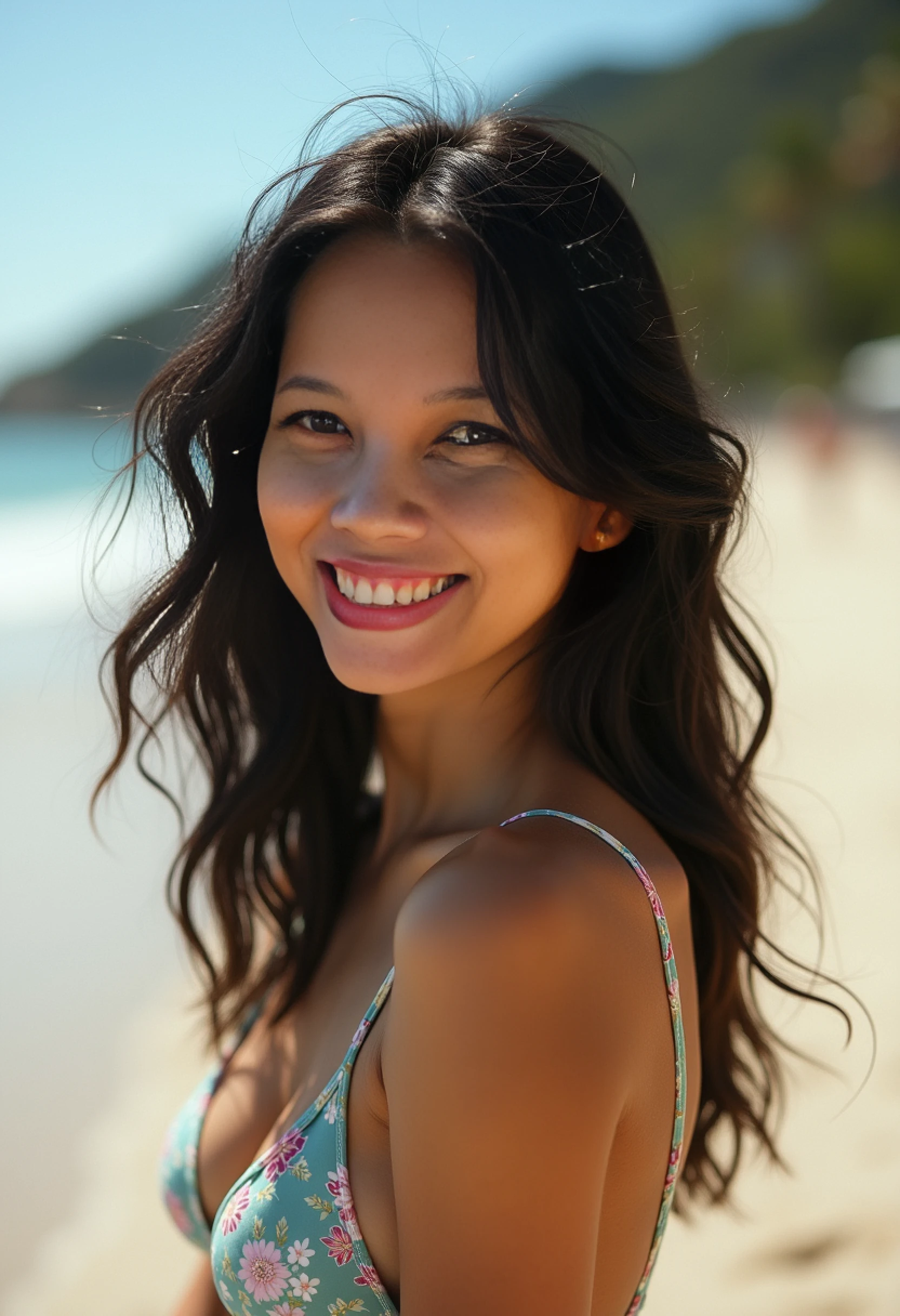 A beautiful girl with a beautiful smile and straight black hair on a beach watching the beautiful sunset