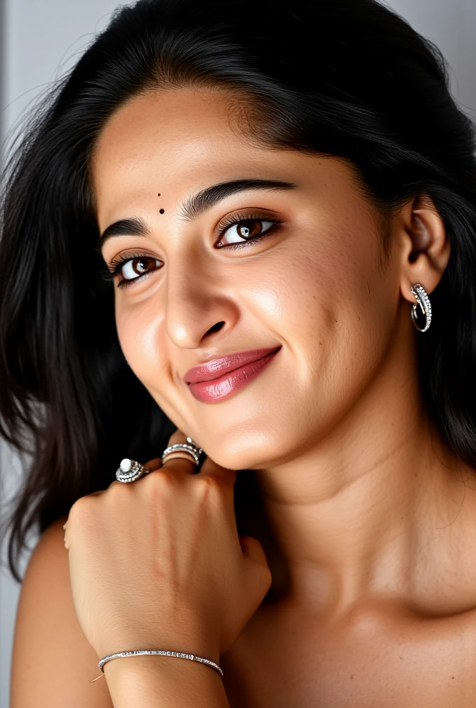 A captivating close-up portrait of Anushka Shetty showcases her stunning visage, with luscious, curly locks framing her face looking at viewer. Her expressive brown eyes, adorned with subtle makeup, take center stage, accompanied by delicate silver earrings and a statement ring. Multiple bangles on her wrists add a touch of sophistication. As she gently rests her hand on her neck, a small decorative bindi adorns her forehead, exuding poise and elegance. The softly blurred background allows her radiant features to take prominence. (Her skin is a masterpiece of detailed realism, featuring blackheads, freckles, and natural red posts, while her eyelashes are lush and her eye pupils shine bright). Perfectly shaped eyebrows complete the portrait's allure.Sharp detailed realistic image of a close up of a person's lips, (detailed skin pore), detailed skin,realism pushed to extreme, fine texture, incredibly lifelike,UHD, 4k, ultra detailed, cinematic,sharp detailed realistic image,AnushkaShettyFlux ,xlr_skin