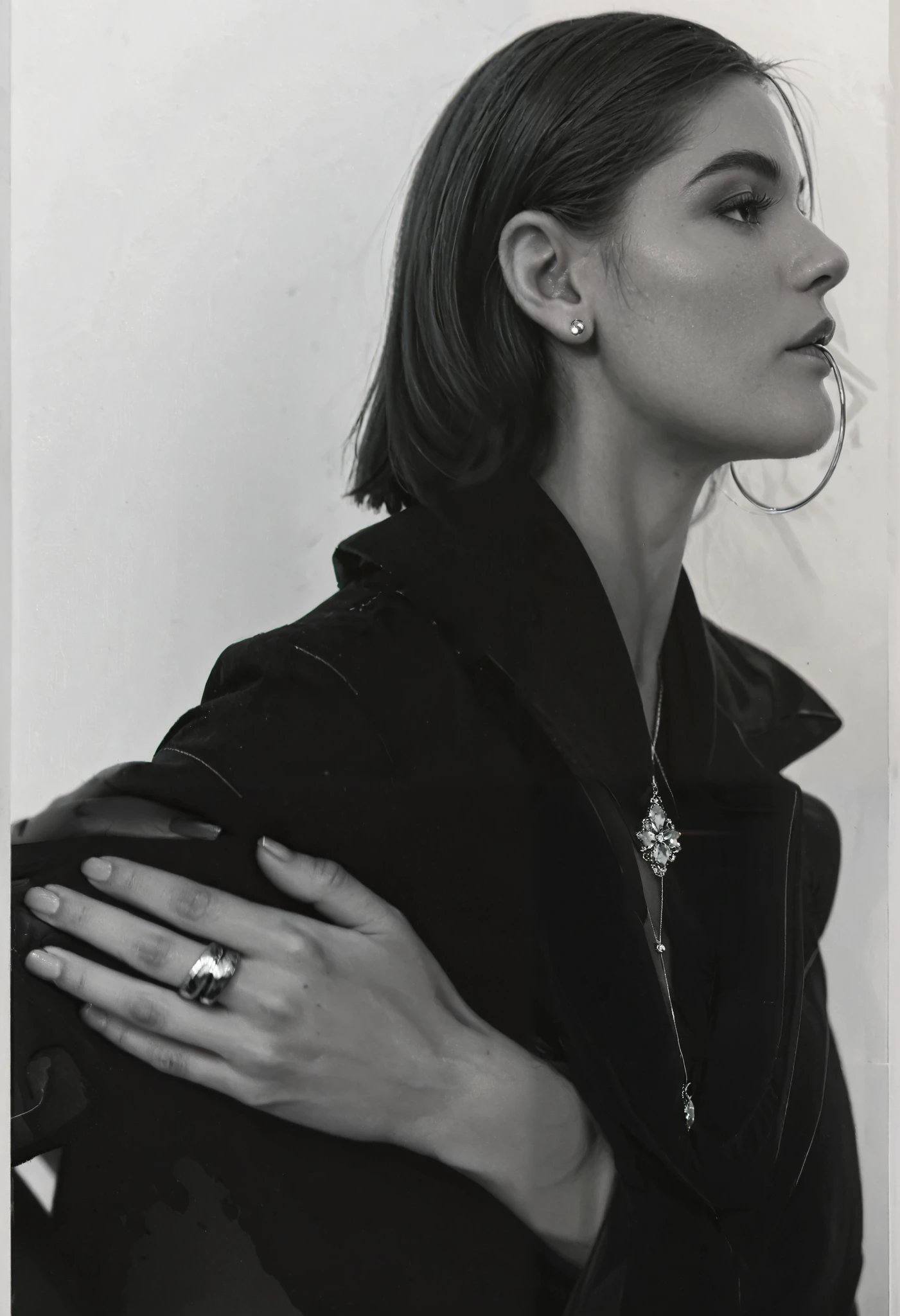 (True profile - side view face), a black and white photo of a woman with a ring on her finger, 