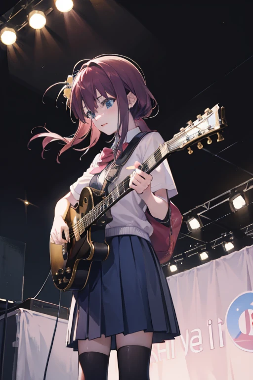 Hitori Gotoh performing with a guitar in a school, outdoors, makeshift stage, warm lighting