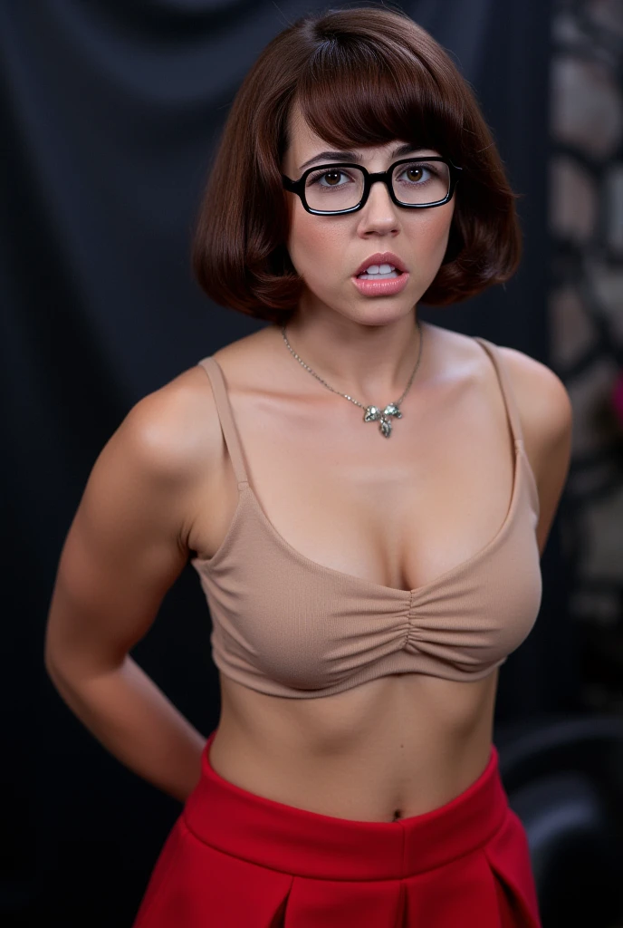 Linda cardelinni, (Velma), (wearing glasses), Adorable eyes, short brown hair, bangs, beautiful face, supermodel face, amazing eyes, (beige bra, red pleted skirt), embarrassed, (annoyed expression on face, frown), (arms behind back), inside a haunted house, aesthetic environment, realistic image, perfect photograph, photoshoot, enhanced details, standing straight