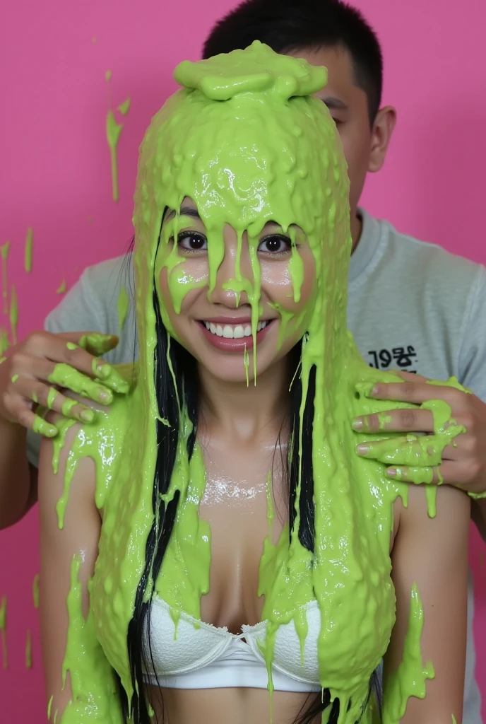 A beautiful Indonesian girl without clothes is holding a cucumber covered in slime in front of the toilet door
