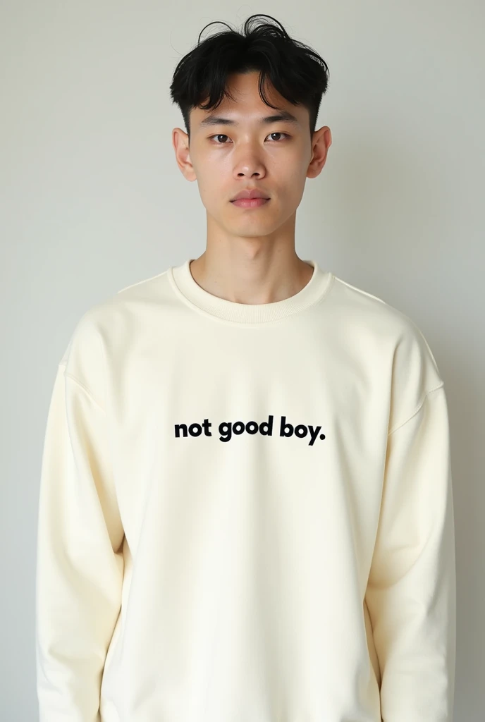 A picture of a white men in cream color sweatshirt, " not good boy " written in black color , on the sweatshirt