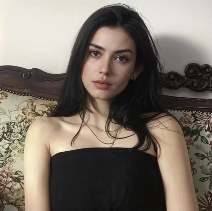 There is a woman sitting on a couch with a black dress - SeaArt AI